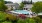 a swimming pool in a courtyard with lounge chairs